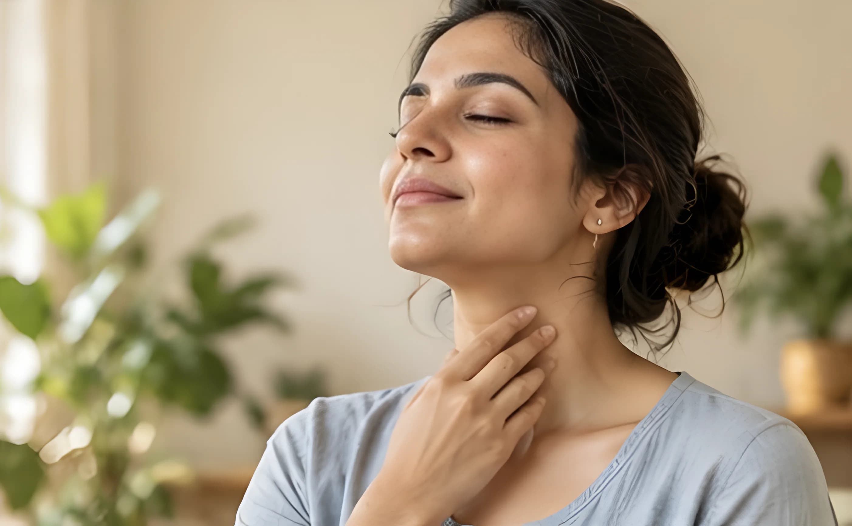 Woman gently touching the front of her neck